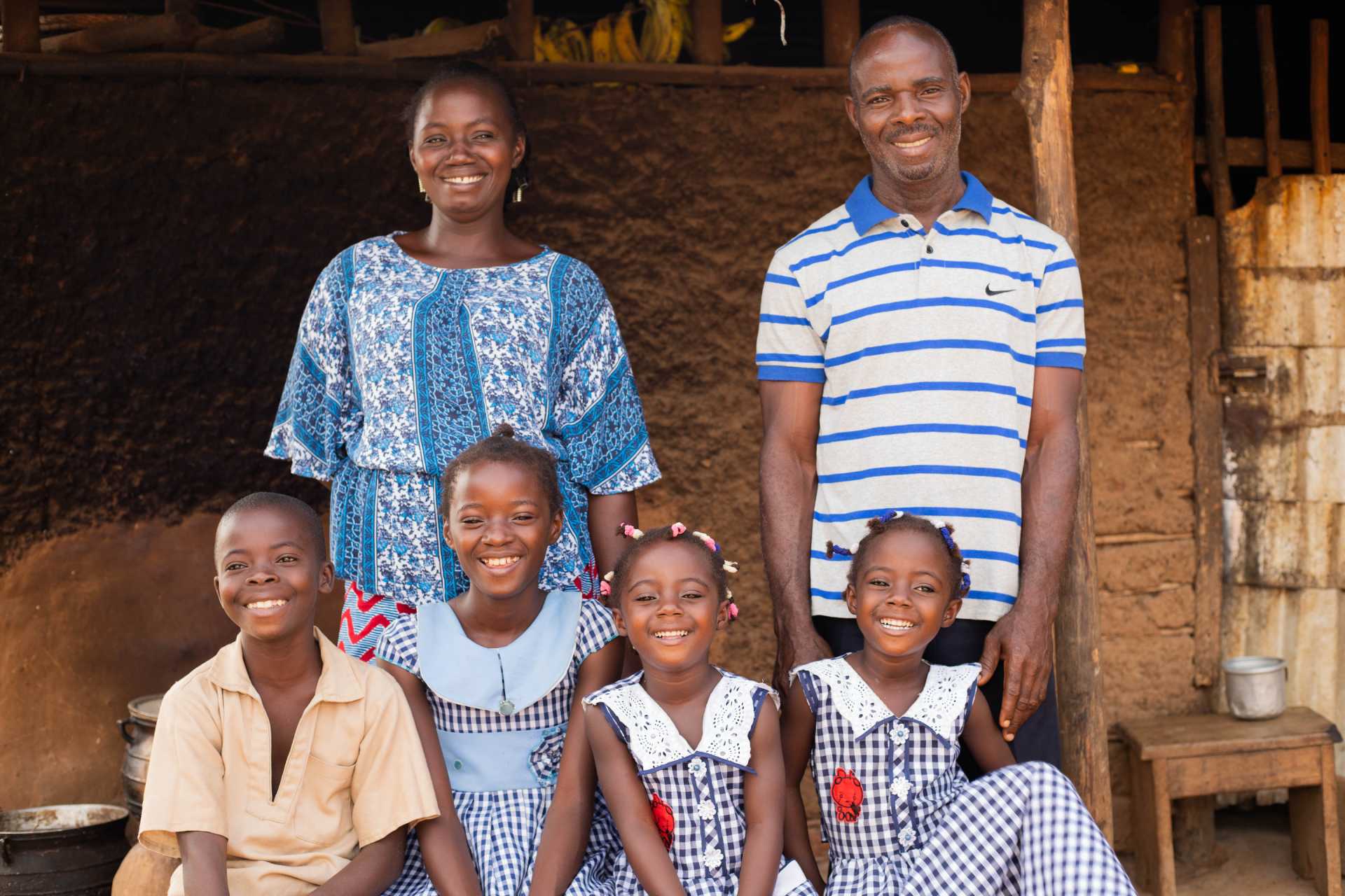 two teachers and four kids smilling