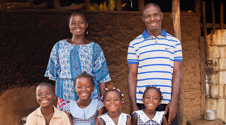 two teachers and four kids smilling